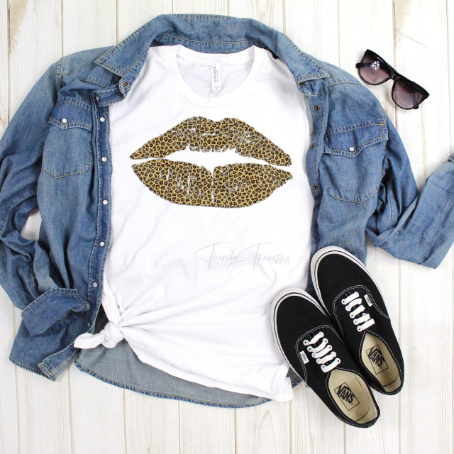Leopard Animal Print Lips Sublimation Transfer, graphic lips design in leopard print on a white t-shirt paired with a denim jacket, sunglasses, and sneakers.