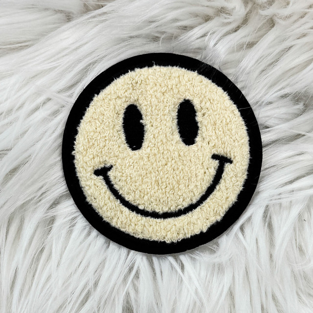 Chenille Smile Face Embroidered Sticker, a round patch featuring a cheerful smiley face with black eyes, a curved smiling mouth, and outlined in black on a soft, fluffy white background.