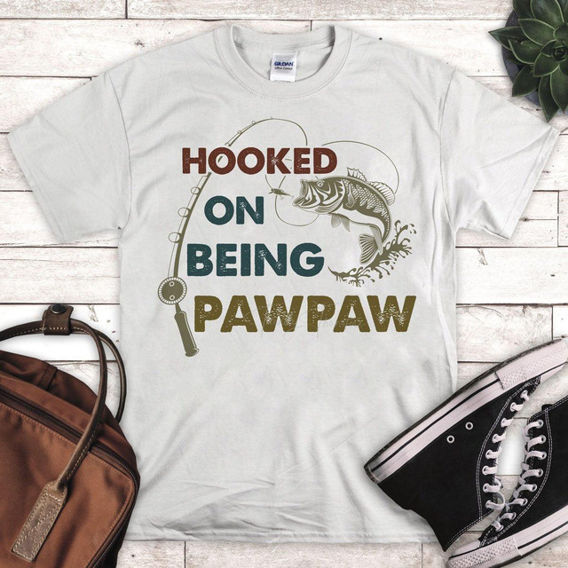 Hooked On Being PawPaw Fishing Sublimation Transfer, t-shirt with fishing-themed design and slogan.