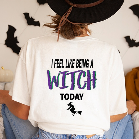 I Feel Like Being A Witch Today DTF Transfer, woman in a witch hat showing back with Halloween decor in background.