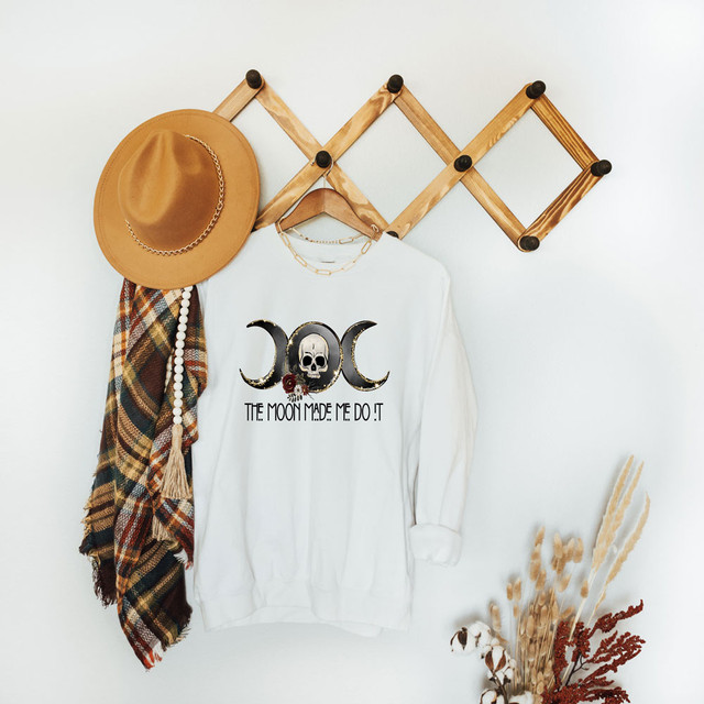 The Moon Made Me Do It Sublimation Transfer, innovative heat transfer design with a skull and moon phases graphic on a white sweatshirt.