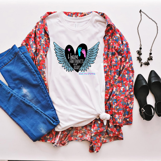 I Have Footprints On My Heart DTF Transfer, a design with angel wings, colorful footprints, and heartfelt text, printed on a white T-shirt.