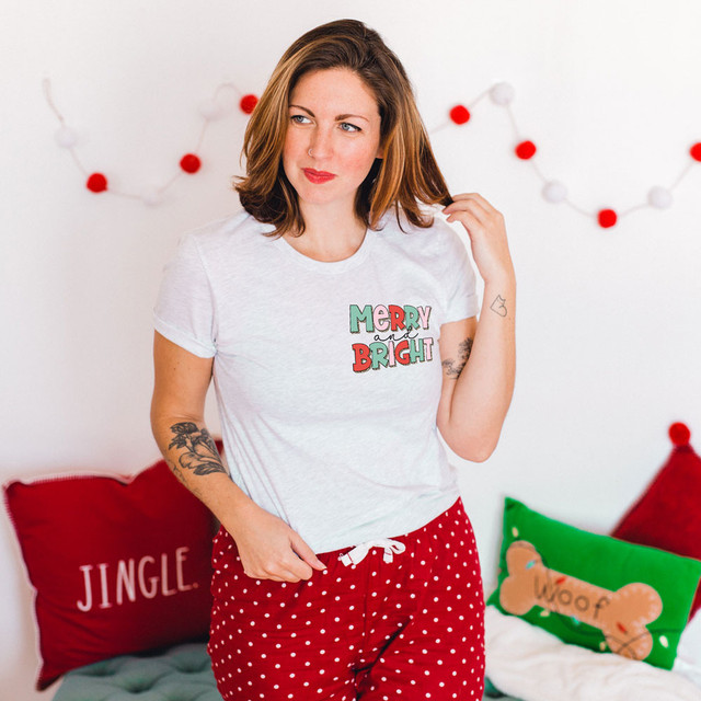 Merry & Bright POCKET Screen Print Heat Transfer, colorful holiday-themed design on a white t-shirt worn by a woman with red hair.