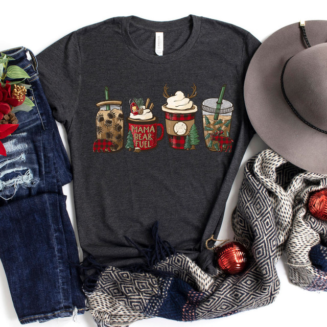 Lumberjack Lattes Screen Print Heat Transfer, festive holiday-themed coffee mugs with marshmallows, reindeer, and Christmas decorations on a dark gray t-shirt.