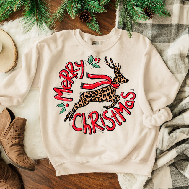 Leopard Reindeer Screen Print Heat Transfer, Christmas holiday sweatshirt featuring a leopard print reindeer with holiday accessories and the greeting 'Merry Christmas'.