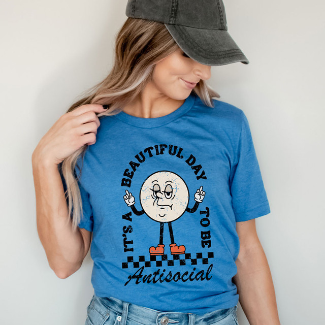 It's A Beautiful Day To Be Antisocial DTF Heat Transfer T-shirt, woman wearing blue t-shirt with a cartoon moon character and the text 'It's A Beautiful Day To Be Antisocial' and 'Autistic'