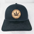 Product A Toke A Day Keeps The Bullshit Away Leather Patch, a black baseball cap with a circular leather patch featuring a cannabis leaf and motivational message.