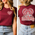 Love Bug DTF Heat Transfer, heart and car graphic design on a maroon t-shirt.