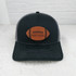Personalized Leather Football Patch, black and gray trucker hat with a football-shaped embroidered patch featuring the word 'PANTHERS' on front.