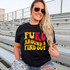 FuKC Around & Find Out DTF Heat Transfer, a colorful printed design on a black T-shirt worn by a smiling woman with sunglasses at an outdoor stadium.