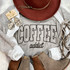 Coffee Addict PUFF Screen Print Heat Transfer, close-up of a stylish outfit with a 'Coffee addict' graphic t-shirt, accessories, jewelry, and boots.