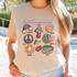 Things That Make Me Happy DTF Heat Transfer, colorful graphic T-shirt design featuring a rainbow, mushroom, smiley face, peace sign, flowers, coffee cup, and cherries.