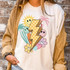 Summer Lightning Bolt DTF Heat Transfer, colorful graphic design featuring a lightning bolt, smiling sun, hearts, flowers, and palm trees on a white T-shirt.