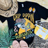 Chip Dippin' & Margarita Sippin' DTF Heat Transfer - colorful graphic t-shirt design with a skeleton wearing a leopard print hat, drinking a margarita, featuring sunglasses, and surrounded by vacation accessories like a hat, earrings, flip-flops, a beach bag, and a beach towel.
