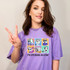 My Emotions In A Day DTF Heat Transfer, colorful cartoon dog characters expressing various emotions on a purple T-shirt.