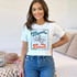 Mama Raised Rebels DTF Heat Transfer, woman wearing white T-shirt with rebellious mama graphic design.
