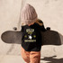 Silly Goose University DTF Heat Transfer, a black t-shirt with a yellow and white graphic of a goose and the words 'Silly Goose University' worn by a young child holding a skateboard.