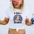 Ben Drankin DTF Heat Transfer, humorous patriotic graphic T-shirt with a caricature of Benjamin Franklin wearing American flag glasses and headband, holding a beer glass.
