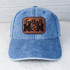 Football Mom Leather Hat Patch, denim baseball cap with a brown leather patch featuring the words 'Football Mom', a football graphic, and a heart design.