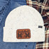 Basketball Mom Leather Hat Patch, white knit beanie with basketball Mom patch and small label reading 'Pacific'.