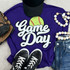 Softball White Game Day Chenille Patch, a white patch with a yellow-green softball and red stitches on a purple shirt with sporty accessories.