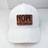 Nope Not Today Leather Hat Patch, white corduroy cap with a brown leather patch embroidered with the phrase "NOPE not today" in black lettering.