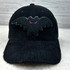 Mini Bat Chenille Patch, black velvety bat-shaped patch with purple embroidered eyes on a black corduroy hat