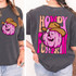 Western Checkered Pumpkin DTF Heat Transfer, a colorful cartoon pumpkin wearing a cowboy hat with the words 'Howdy Pumpkin' in vibrant pink and peach colors on a black t-shirt.