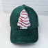 Mini Snack Cake Sequin Patch, sewn on a green corduroy baseball cap with a Christmas tree design
