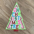 Sequin Christmas Tree Patch, colorful embroidered Christmas tree design with the words 'Oh Christmas I S T M A S T R E E' in various bright colors on a wooden surface.