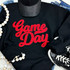 NO SPORT Red Game Day Chenille Patch, red embroidered patch on black sweatshirt with 'Game Day' text.