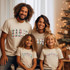 Dad Plaid DTF Heat Transfer, family wearing matching Christmas T-shirts with plaid pattern text reading 'DAD', 'SISTER', 'BROTHER', and 'IAM' in a festive indoor setting with Christmas tree and decorations.