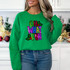 Oh What Fun Sequin Patch, colorful festive holiday-themed patch with holly and berry designs on a green sweatshirt.
