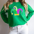 Sequin Jester Hat Patch, colorful embroidered patch featuring a jester hat with green, purple, yellow, and pink sequins on a woman's green sweatshirt.