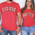 Hubby Plaid DTF Heat Transfer, a colorful plaid pattern text transfer applied on matching red T-shirts for couple matching outfits.