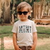 Mini Cowhide Blue DTF Heat Transfer, a fashion transfer design with cowhide pattern on the word 'MINI' printed on a child's t-shirt.