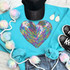 RAINBOW HEART Sequin Patch, colorful heart-shaped sequin patch on a turquoise sweatshirt.