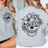 One Day At A Time Floral Skull DTF Heat Transfer, a graphic design featuring a skull adorned with flowers and a banner with the printed phrase.