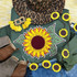 Sunflower Chenille Patch, a bright yellow sunflower embroidered patch with green leaves on a green fabric background.