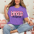Loved Mama DTF Heat Transfer, pink and black lettering design on a purple T-shirt with hearts for moms.