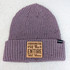 Coordinator Of The Entire Shit Show Leather Hat Patch, a knit purple beanie hat with a leather patch that reads 'Coordinator Of The Entire Shit Show.'