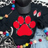 Dog Paw Red Chenille Patch, bright red chenille dog paw print patch on black fabric clothing item.