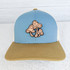 Mushrooms Leather Hat Patch, embroidered patch of three stylized mushrooms with spots on a blue and beige trucker cap.
