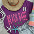 Beach Babe NEON Screen Print Heat Transfer, vibrant pink and neon green beach-themed design on purple t-shirt with starfish, palm trees, earrings, and beach accessories.