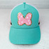 Pink Bow POLKA DOTS Glitter Chenille HAT/POCKET Patch, a turquoise cap featuring a pink embroidered bow with white polka dots, outlined with gold glitter.