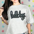 Bulldogs Sequin Patch, the image showcases a woman wearing a casual gray T-shirt with a 'bulldogs' sequin patch design on the front.