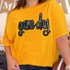 Game Day Sequin Patch, a black and silver sparkling embroidered patch with the text 'game day' on a yellow T-shirt.