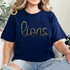 Lions Sequin Patch, a black and silver embroidered lion design on navy blue fabric T-shirt with the word 'lions' in cursive font.
