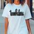 Touchdown Sequin Patch, a black and silver sequined patch featuring the word 'touchdown' in cursive font on a white t-shirt.