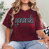 Generals Sequin Patch, a glittering patch with the word 'generals' on a maroon T-shirt worn by a woman with blonde hair.